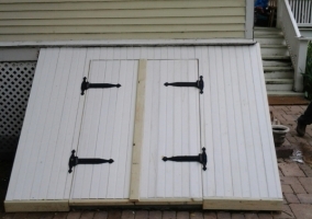 New exterior basement stair door and cover built on Victorian Home